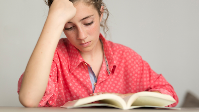 teen girl reading novel
