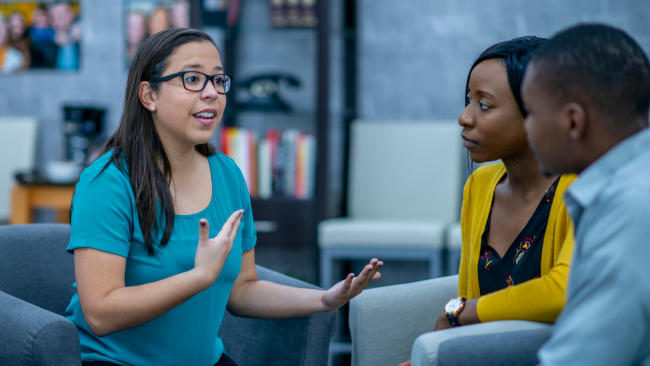 Psychologist talking to parents on couch